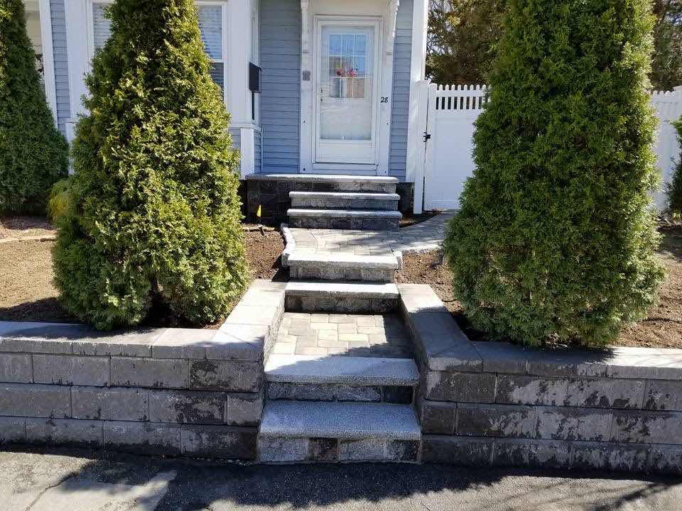 Granite and segmental block entry steps with matching retaining walls, built by Magic Tools Contracting