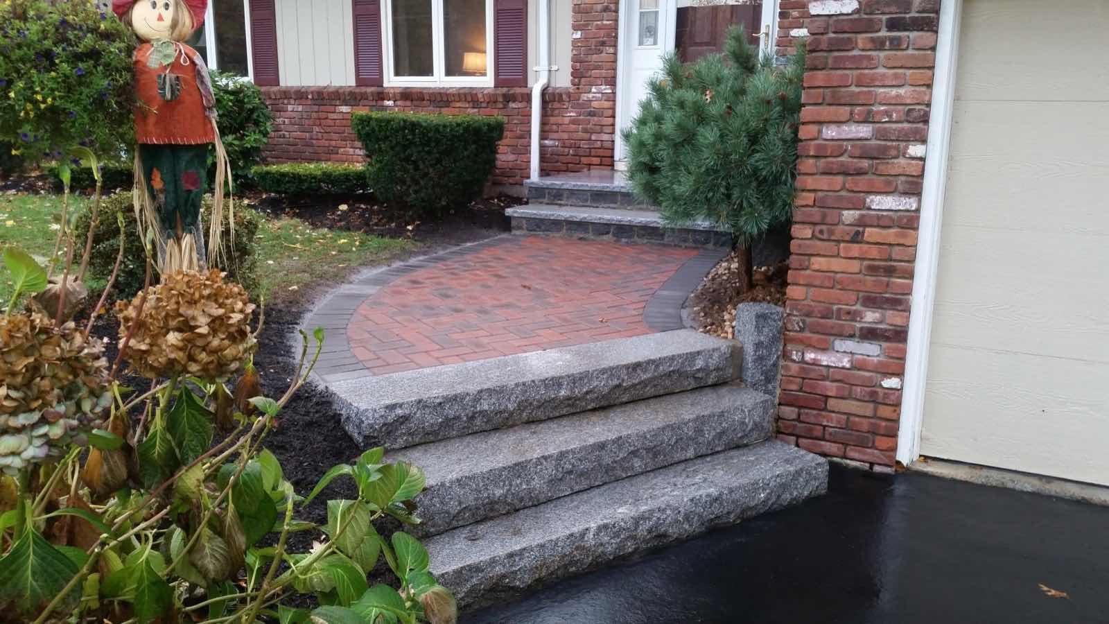 Circular herringbone brick front walkway with granite entry steps, installed by Magic Tools Contracting