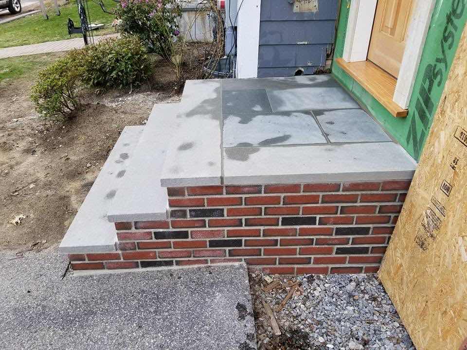 Brick veneer entry steps under construction on a new home addition, built by Magic Tools Contracting