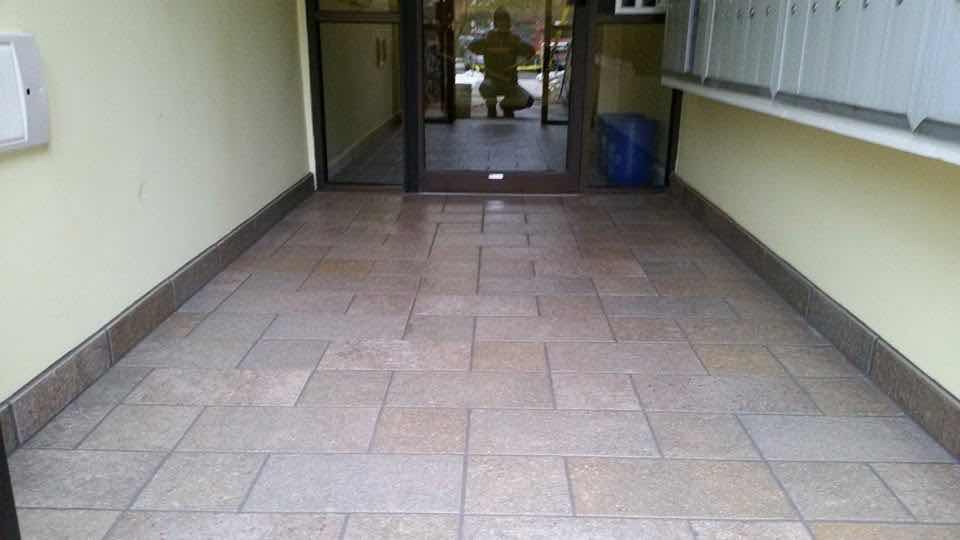 Diagonal tile flooring installed in an apartment building entryway by Magic Tools Contracting